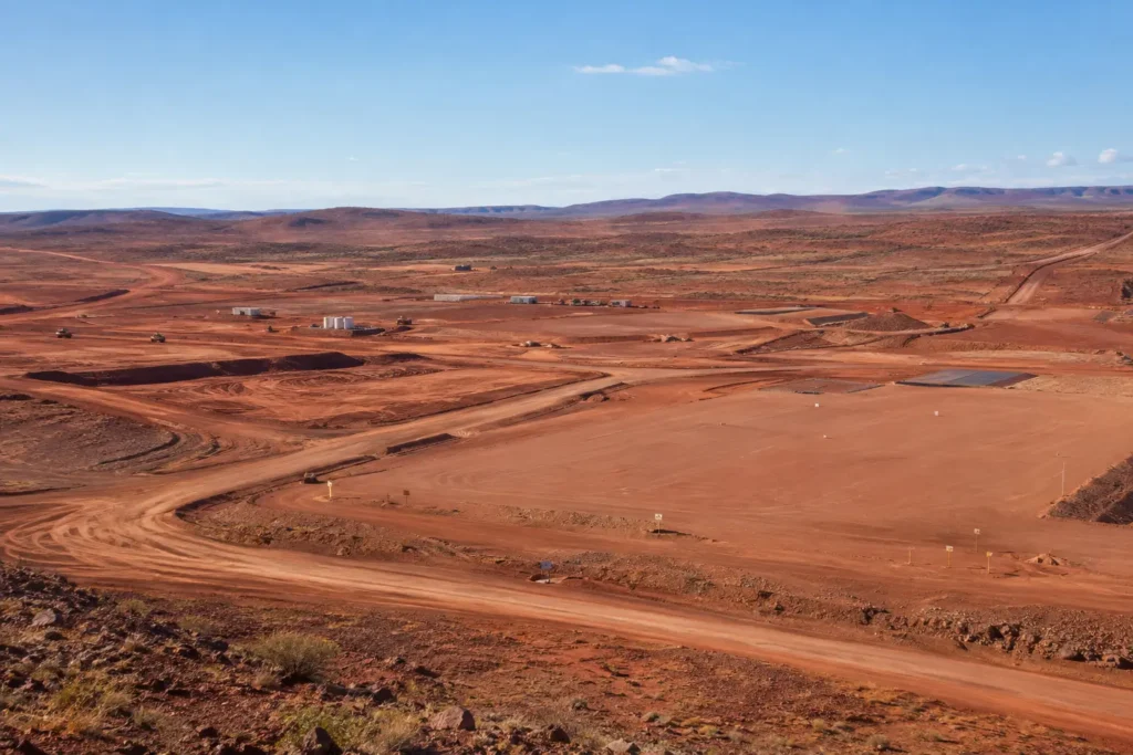 Newly graded access road leading to a remote Australian mining project.